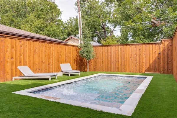 a view of a backyard with wooden fence