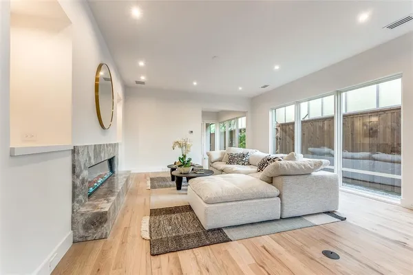 a living room with furniture fireplace and wooden floor