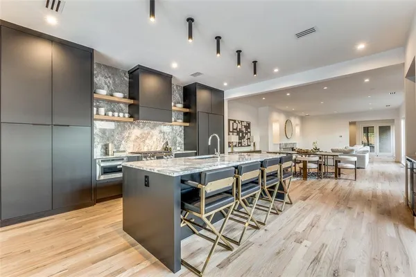 a kitchen with lots of counter top space and stainless steel appliances