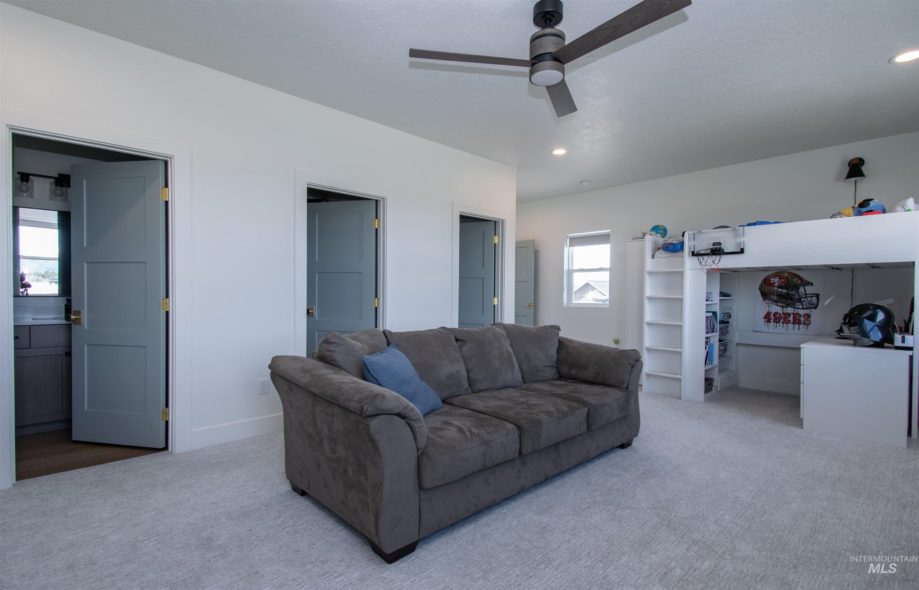 44 Big Moose Road McCall, ID 83638 - Photo 33 of 50 Spacious room featuring light gray carpeting, a contemporary ceiling fan, recessed lighting, and white walls
