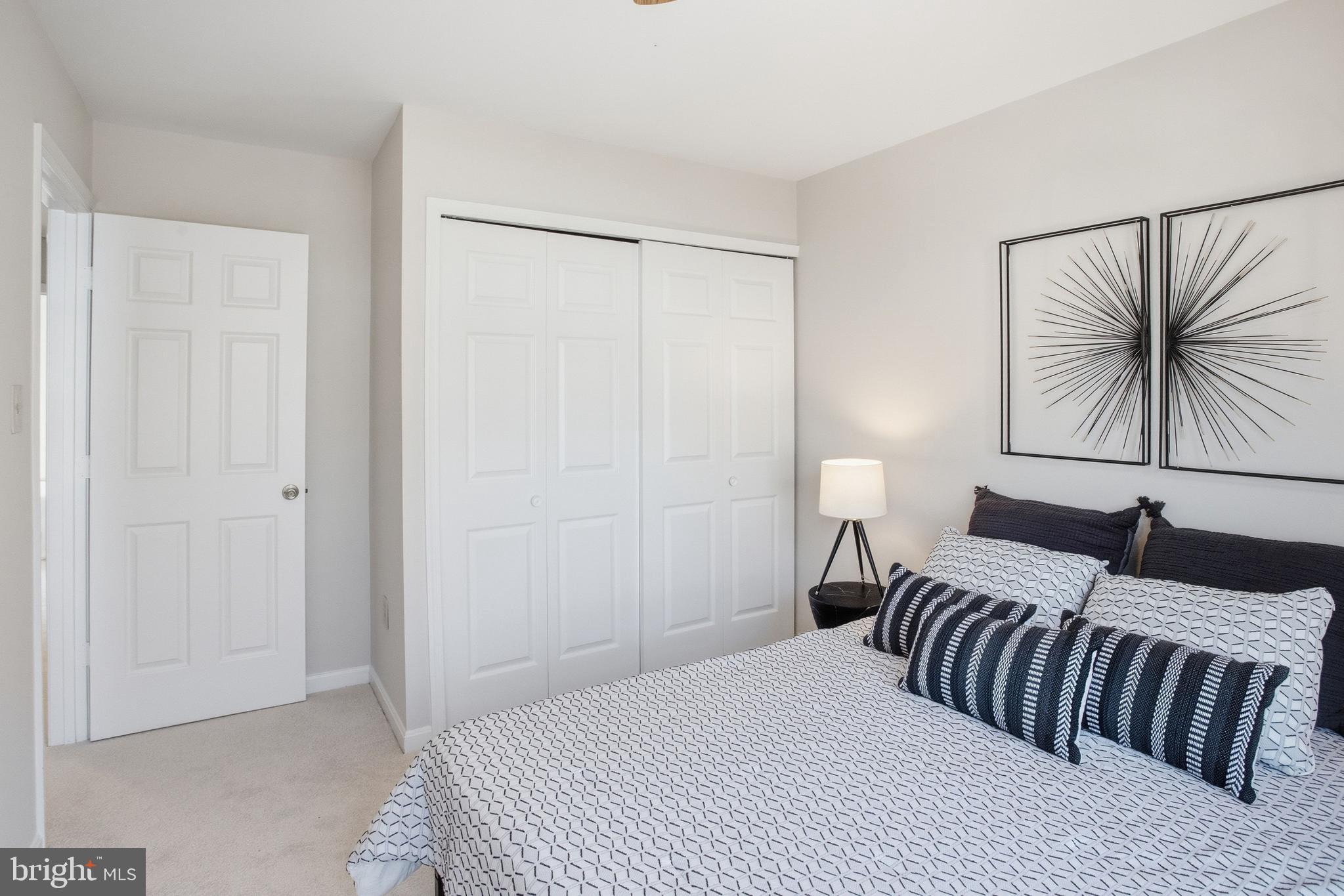 5251 Spring Branch Boulevard Dumfries, VA 22025 - Photo 16 of 25 a bedroom with a bed and a chandelier