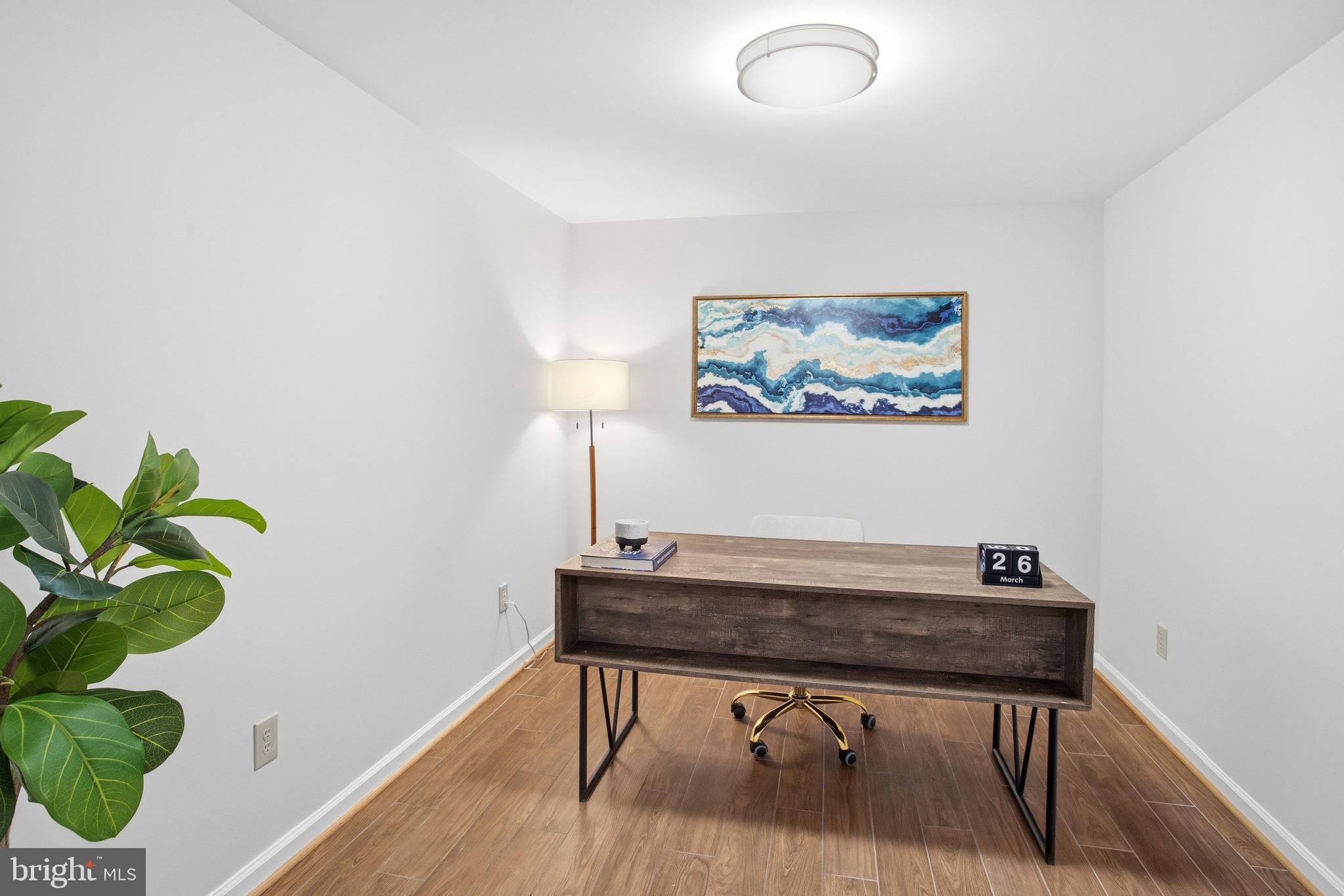 5251 Spring Branch Boulevard Dumfries, VA 22025 - Photo 17 of 25 a view of workspace with wooden floor and a potted plant