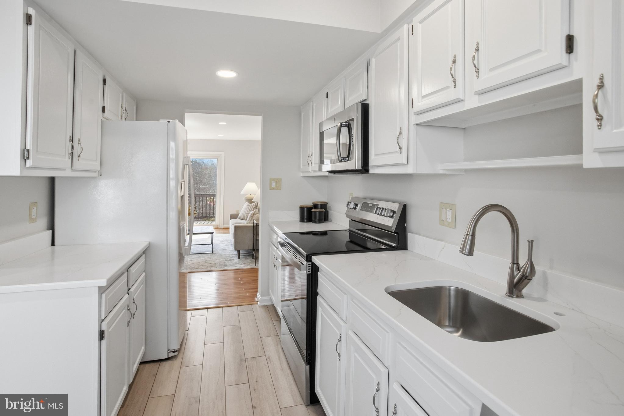 5251 Spring Branch Boulevard Dumfries, VA 22025 - Photo 5 of 25 a kitchen with stainless steel appliances granite countertop a sink stove and refrigerator