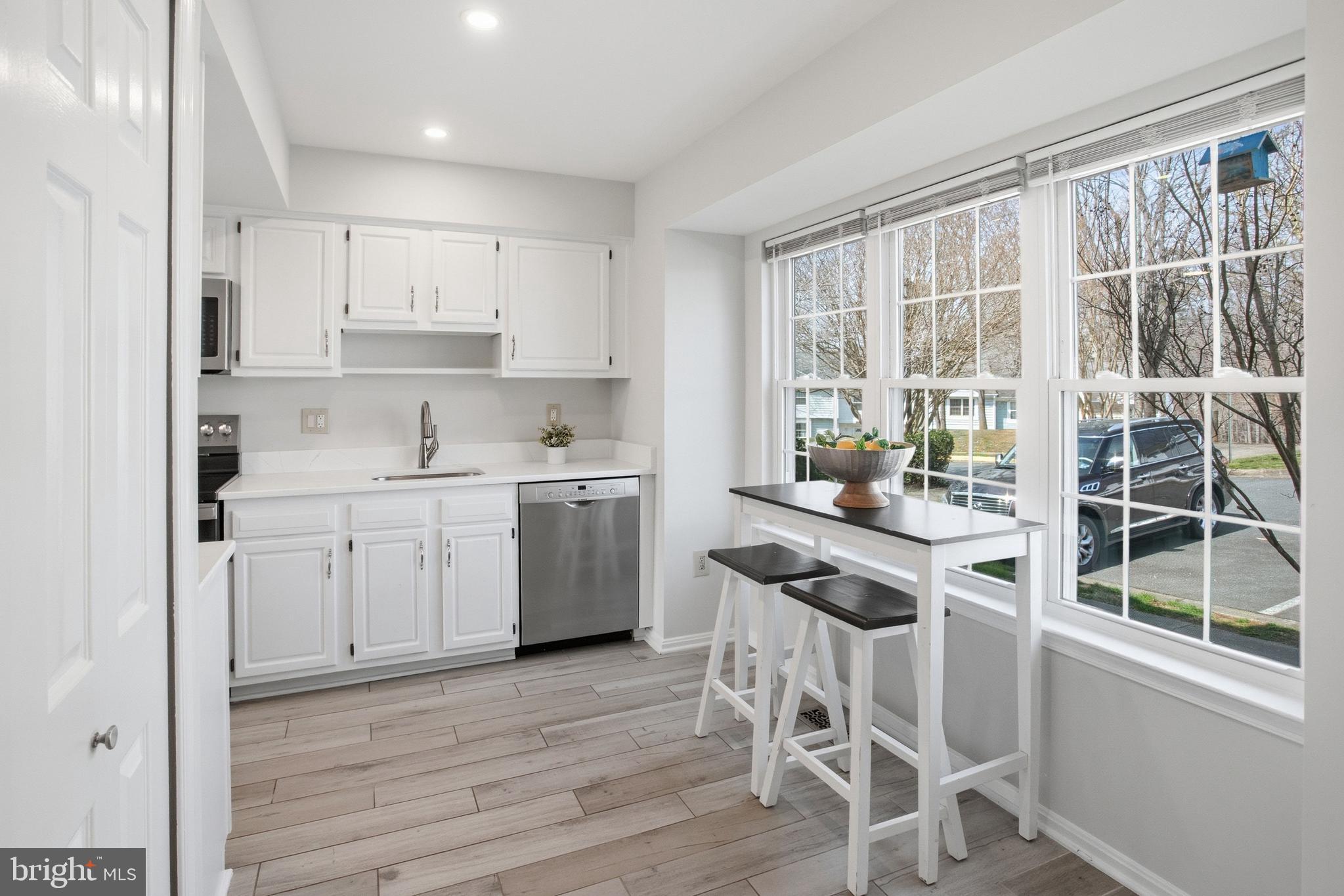 5251 Spring Branch Boulevard Dumfries, VA 22025 - Photo 6 of 25 a kitchen with a sink window and cabinets
