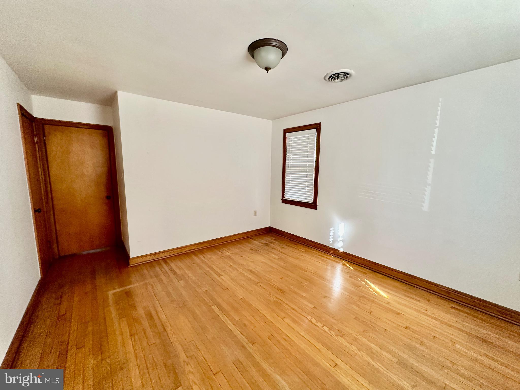 939 View Street Hagerstown, MD 21742 - Photo 12 of 24 a view of an empty room with wooden floor and a window