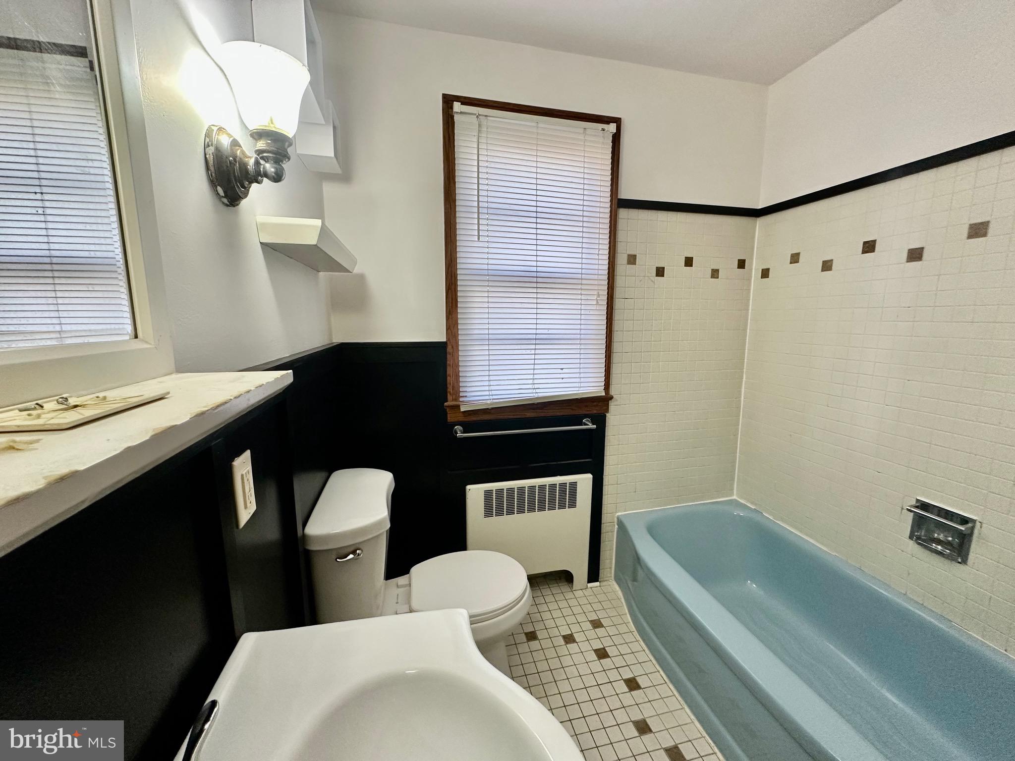 939 View Street Hagerstown, MD 21742 - Photo 16 of 24 a bathroom with a sink a toilet a mirror and shower