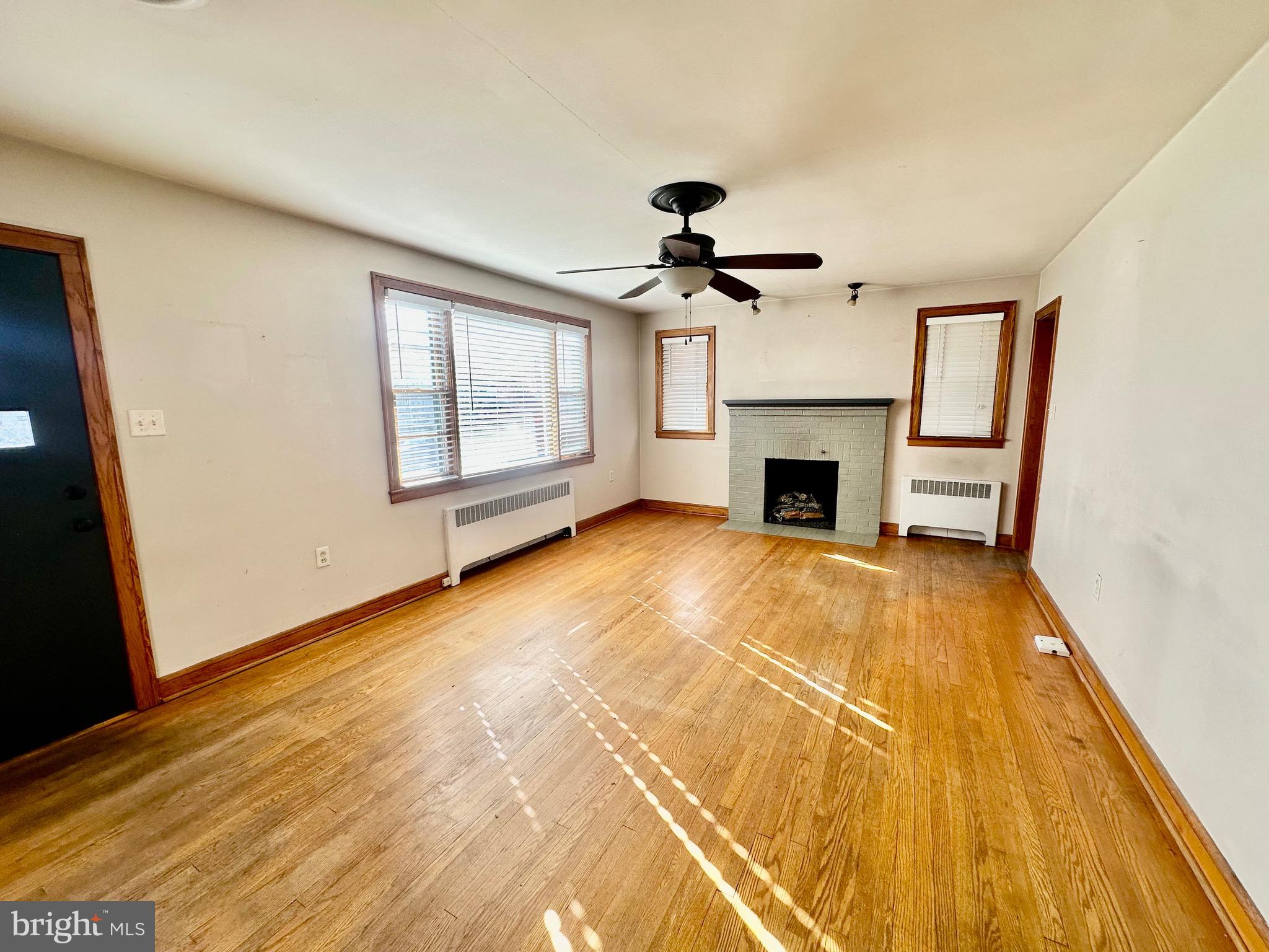 939 View Street Hagerstown, MD 21742 - Photo 5 of 24 a view of an empty room with a fireplace and a window
