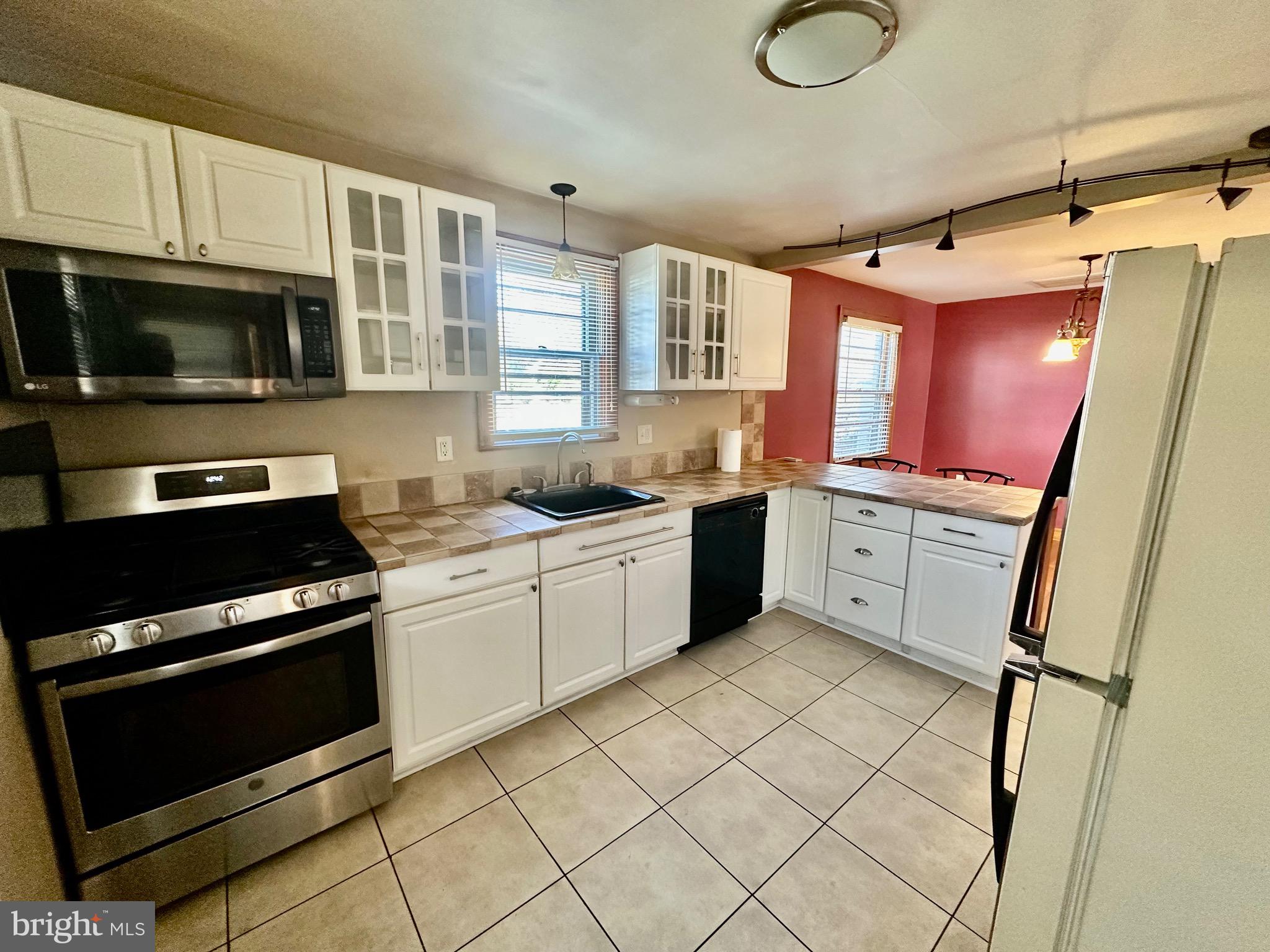 939 View Street Hagerstown, MD 21742 - Photo 7 of 24 a kitchen with stainless steel appliances granite countertop a stove a sink and a microwave