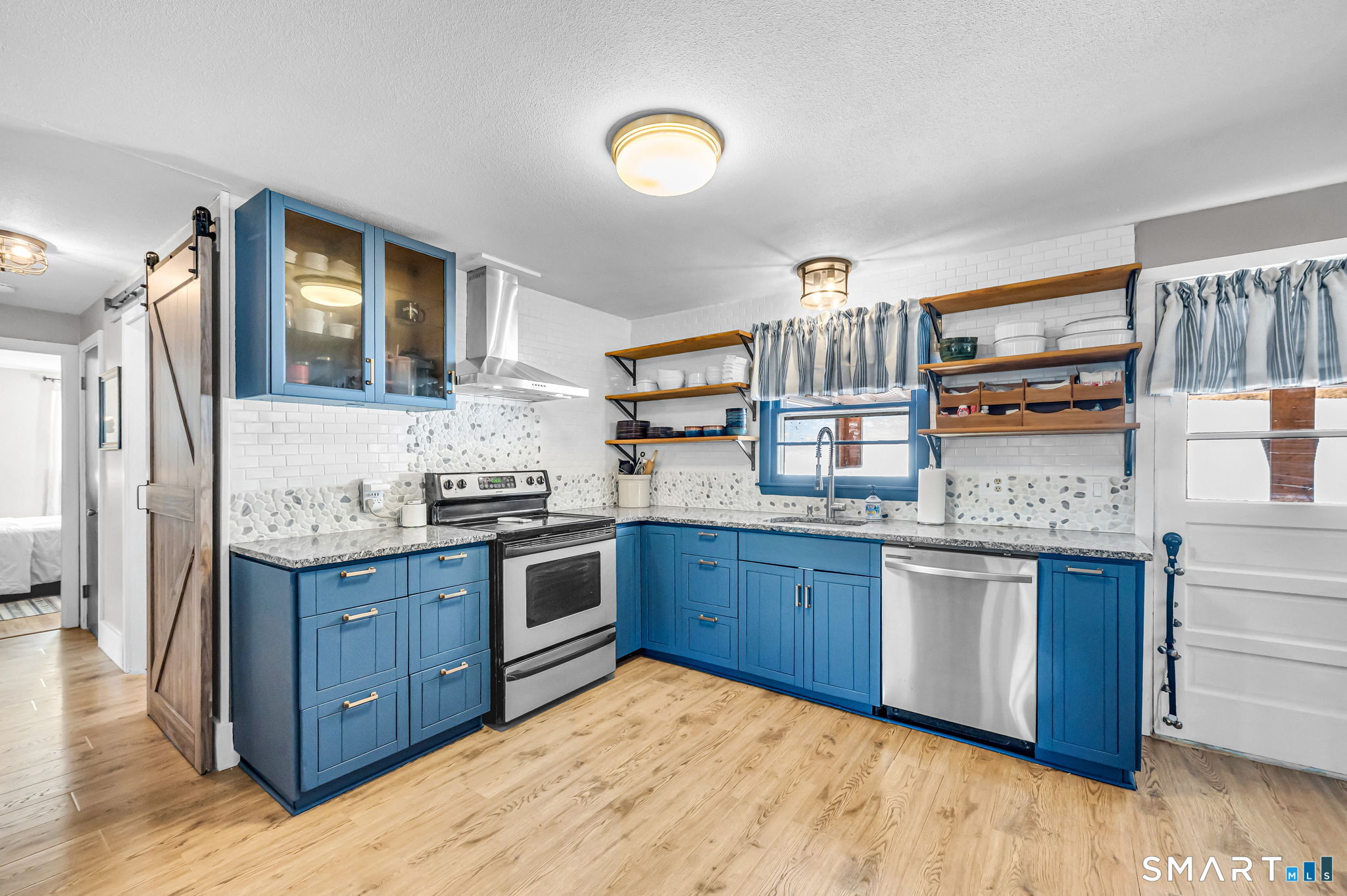 9 Hale Road Enfield, CT 06082 - Photo 12 of 40 a kitchen with stainless steel appliances granite countertop a stove and cabinets