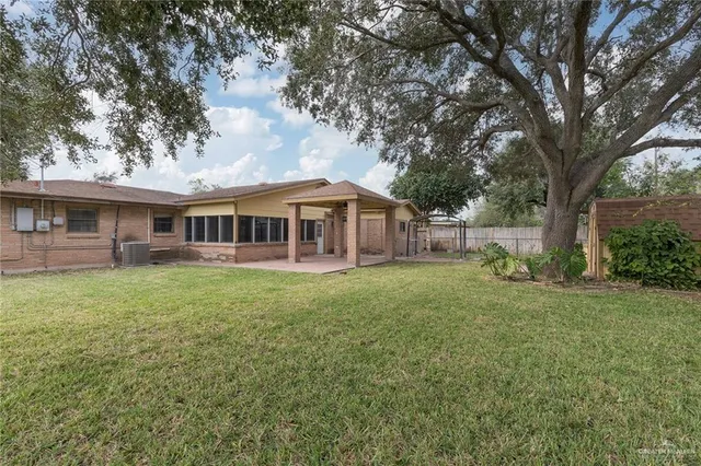 a view of a house with a backyard
