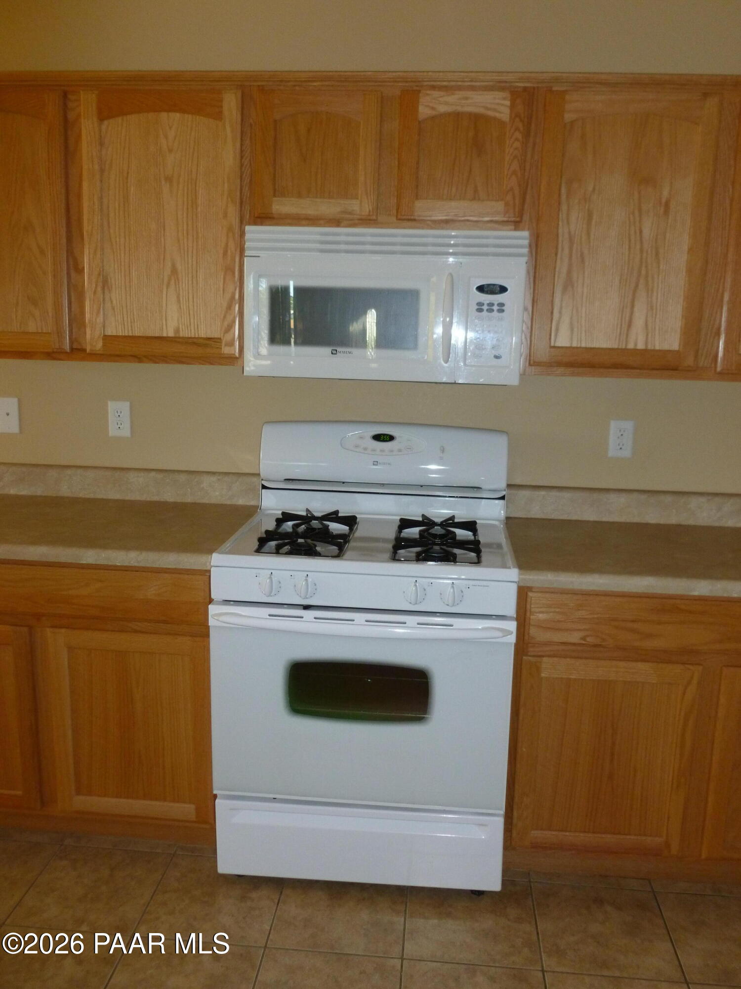 3416 North Victor Road, Unit 1 Prescott Valley, AZ 86314 - Photo 11 of 27 a stove top oven sitting inside of a kitchen