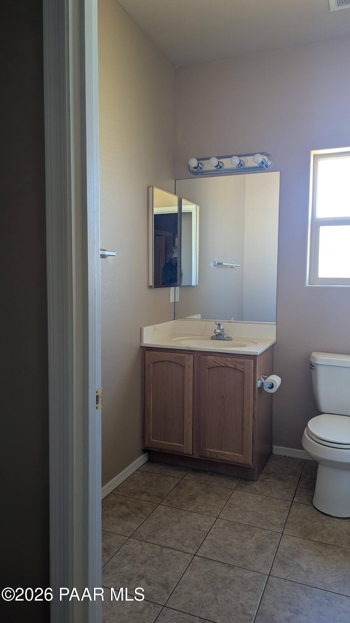 3416 North Victor Road, Unit 1 Prescott Valley, AZ 86314 - Photo 22 of 27 a bathroom with a sink toilet and mirror