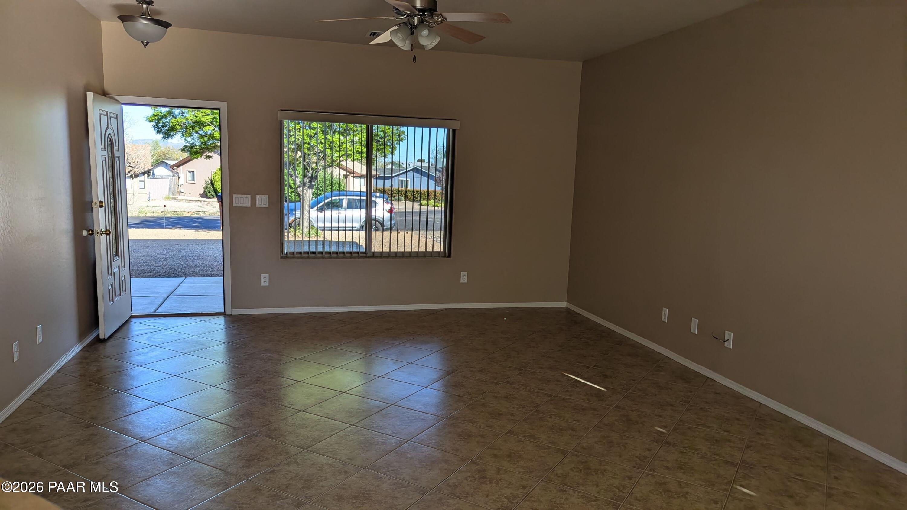 3416 North Victor Road, Unit 1 Prescott Valley, AZ 86314 - Photo 5 of 27 an empty room with wooden floor and windows