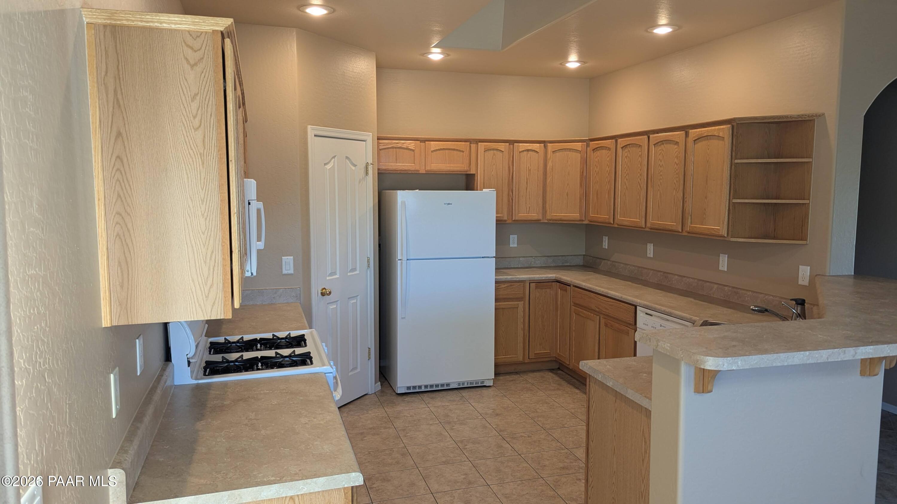 3416 North Victor Road, Unit 1 Prescott Valley, AZ 86314 - Photo 10 of 27 a kitchen with stainless steel appliances granite countertop a refrigerator and a sink