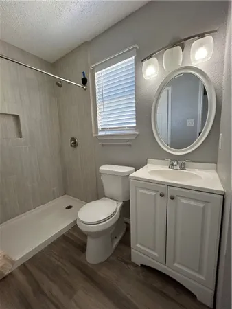 a bathroom with a toilet sink and mirror