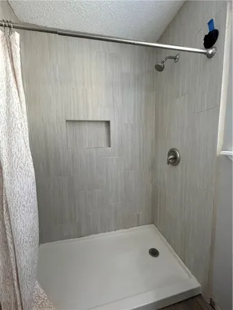 a bathroom with a bathtub and shower