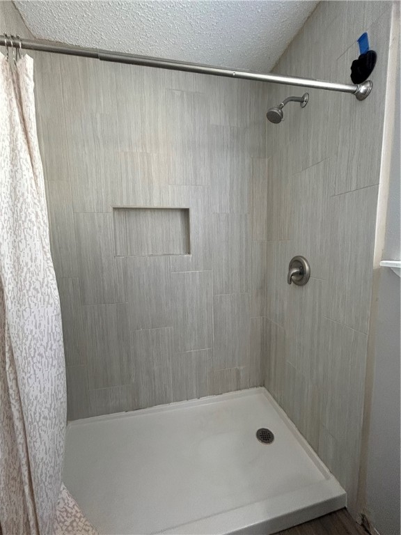 6702 Everhart Road, Unit I105 Corpus Christi, TX 78413 - Photo 12 of 19 a bathroom with a bathtub and shower
