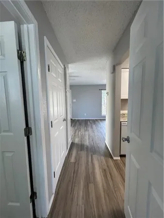 a view of a hallway view with wooden floor and staircase