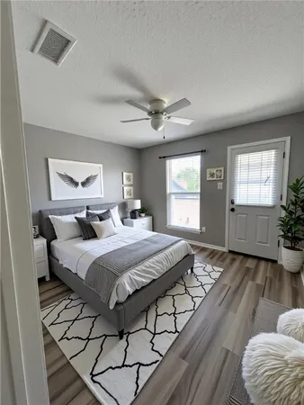 a spacious bedroom with a bed and window