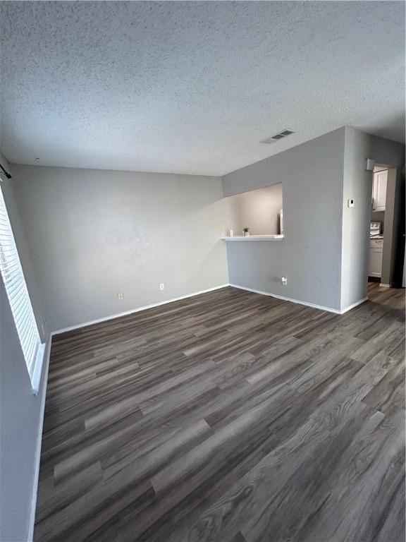 6702 Everhart Road, Unit I105 Corpus Christi, TX 78413 - Photo 3 of 19 an empty room with wooden floor and windows