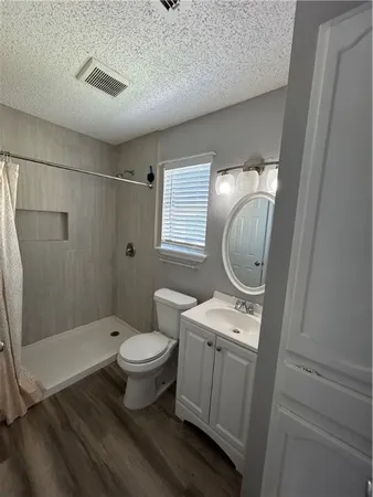 a bathroom with a toilet sink and shower