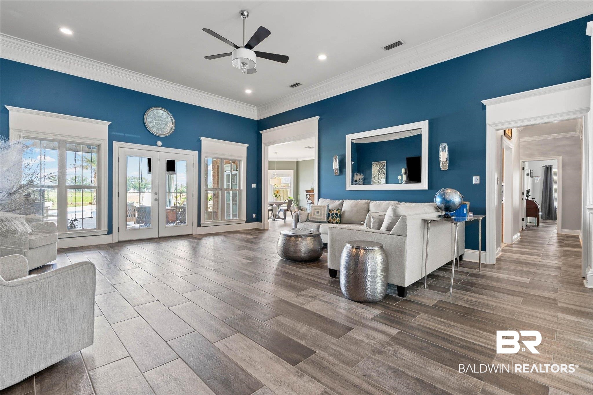 24908 Bosbyshell Avenue Daphne, AL 36526 - Photo 23 of 49 Spacious living area featuring wood-finish tile flooring, a ceiling fan with integrated lighting, recessed lighting, and crown molding
