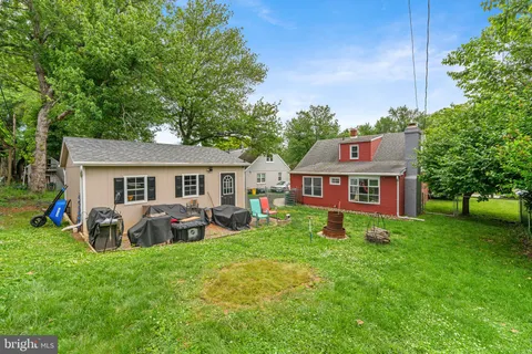 a view of a house with a yard and sitting area