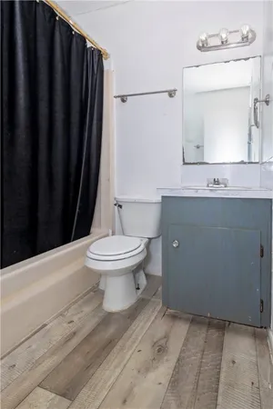 a bathroom with a toilet a sink and a mirror