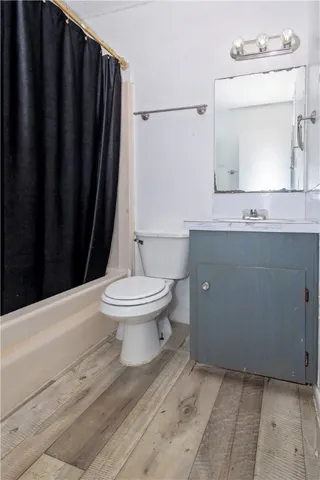 a bathroom with a toilet a sink and a mirror