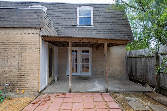 a view of a brick house with a large window