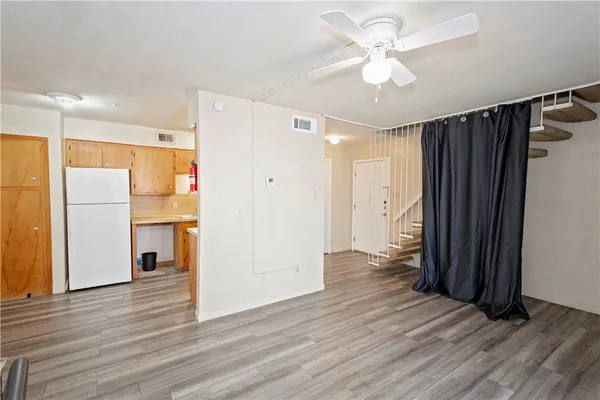 a view of a refrigerator in kitchen and wooden floor