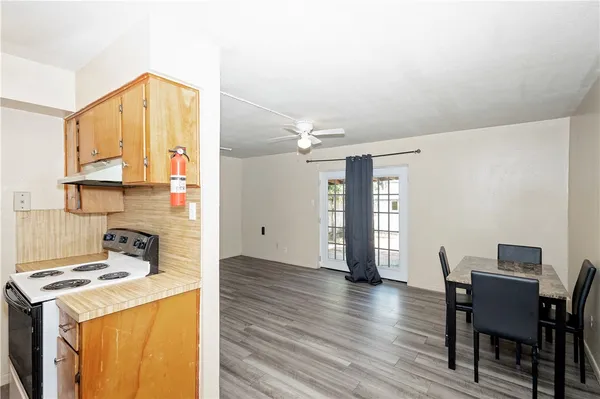 a kitchen with a stove a refrigerator and a dining table