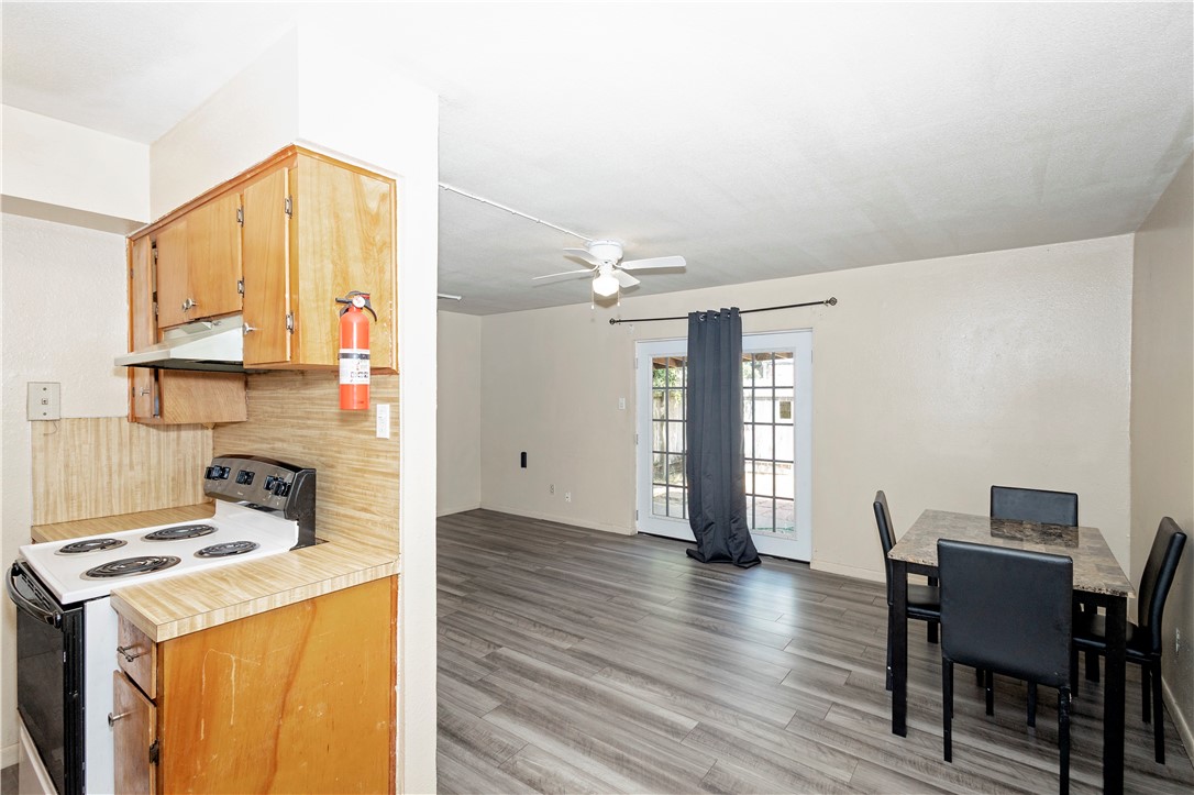 5030 Meandering Lane, Unit 5030 Corpus Christi, TX 78413 - Photo 5 of 15 a kitchen with a stove a refrigerator and a dining table