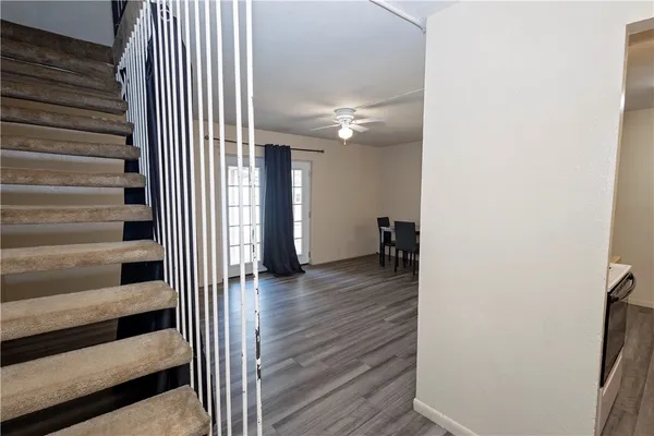 a view of a hallway with wooden floor and entryway