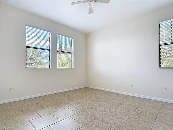 an empty room with windows and closet