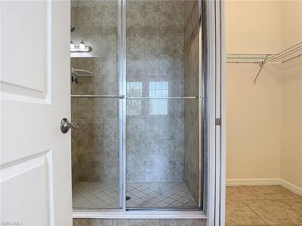 a bathroom with a shower and a mirror