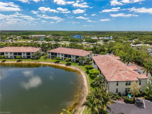 an aerial view of residential houses with outdoor space and ocean