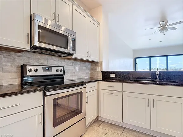 a large kitchen with cabinets and stainless steel appliances