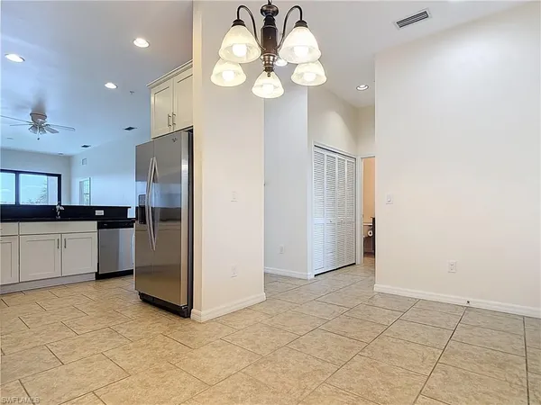 a kitchen with stainless steel appliances granite countertop a refrigerator a stove and a sink