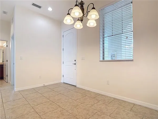 a view of an empty room with a kitchen
