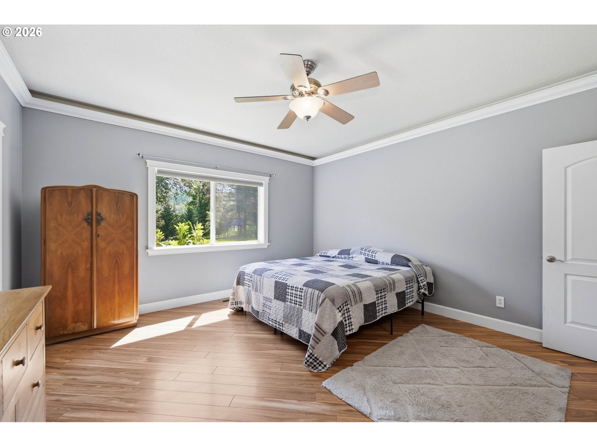 29778 Gimpl Hill Road Eugene, OR 97405 - Photo 16 of 43 a bedroom with a bed and wooden floor