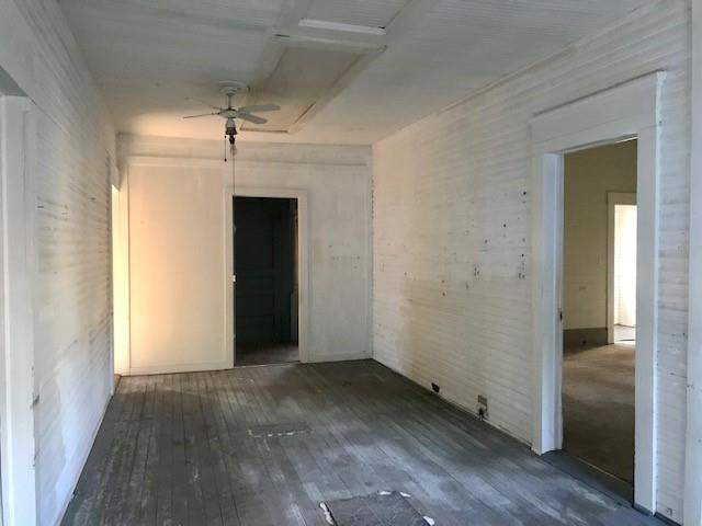 6962 Redbud Lane Ida, LA 71044 - Photo 11 of 40 an empty room with wooden floor cabinet and windows