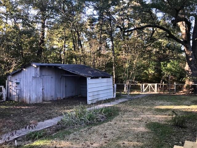 6962 Redbud Lane Ida, LA 71044 - Photo 33 of 40 a view of a backyard with large trees and wooden fence