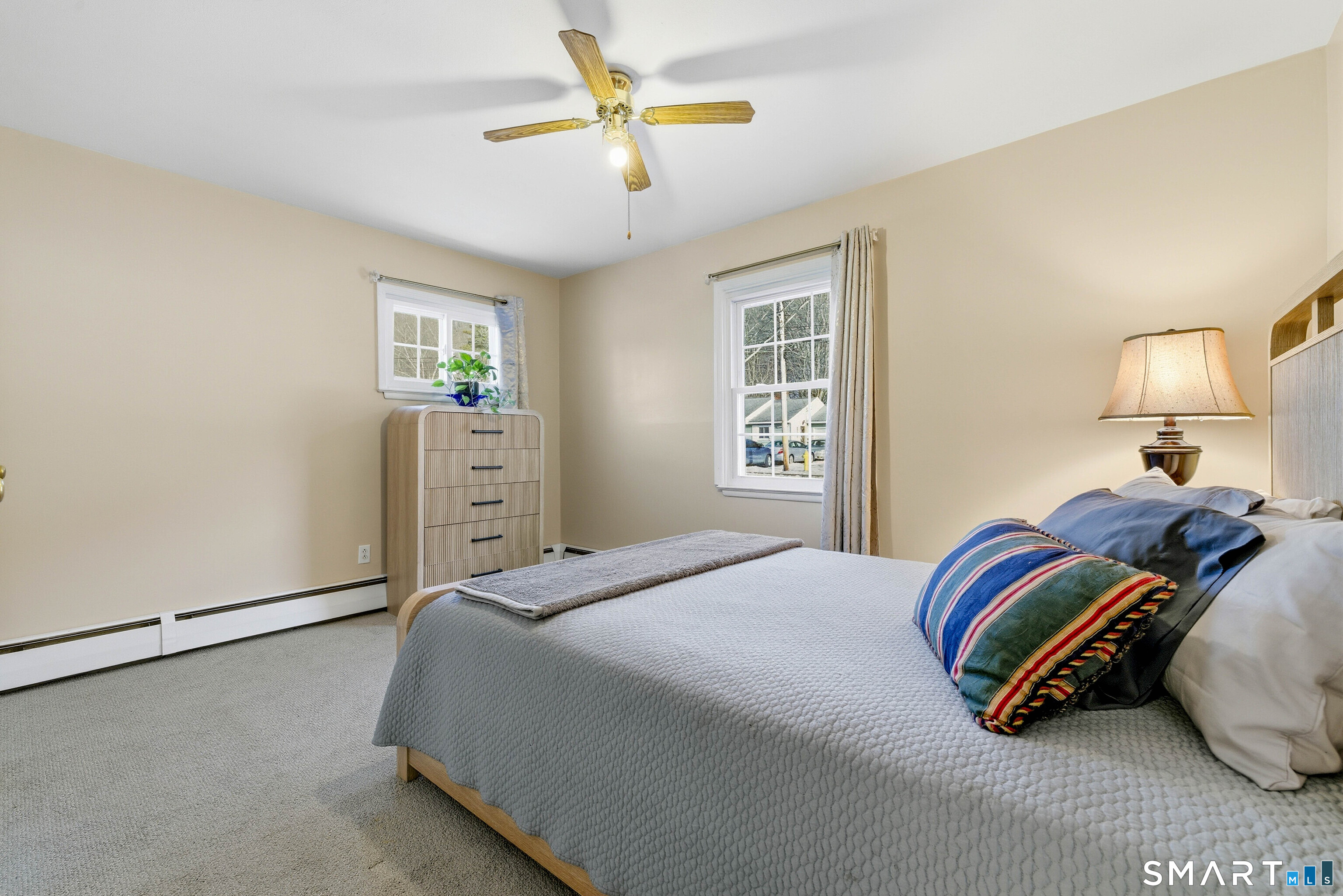 57 Hellstrom Road East Haven, CT 06512 - Photo 17 of 36 a bedroom with a bed and a chandelier