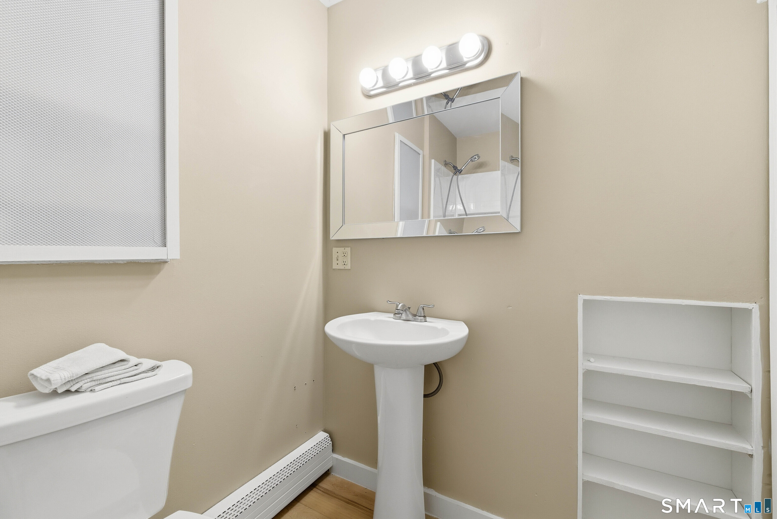 57 Hellstrom Road East Haven, CT 06512 - Photo 20 of 36 a bathroom with a sink a mirror and a toilet