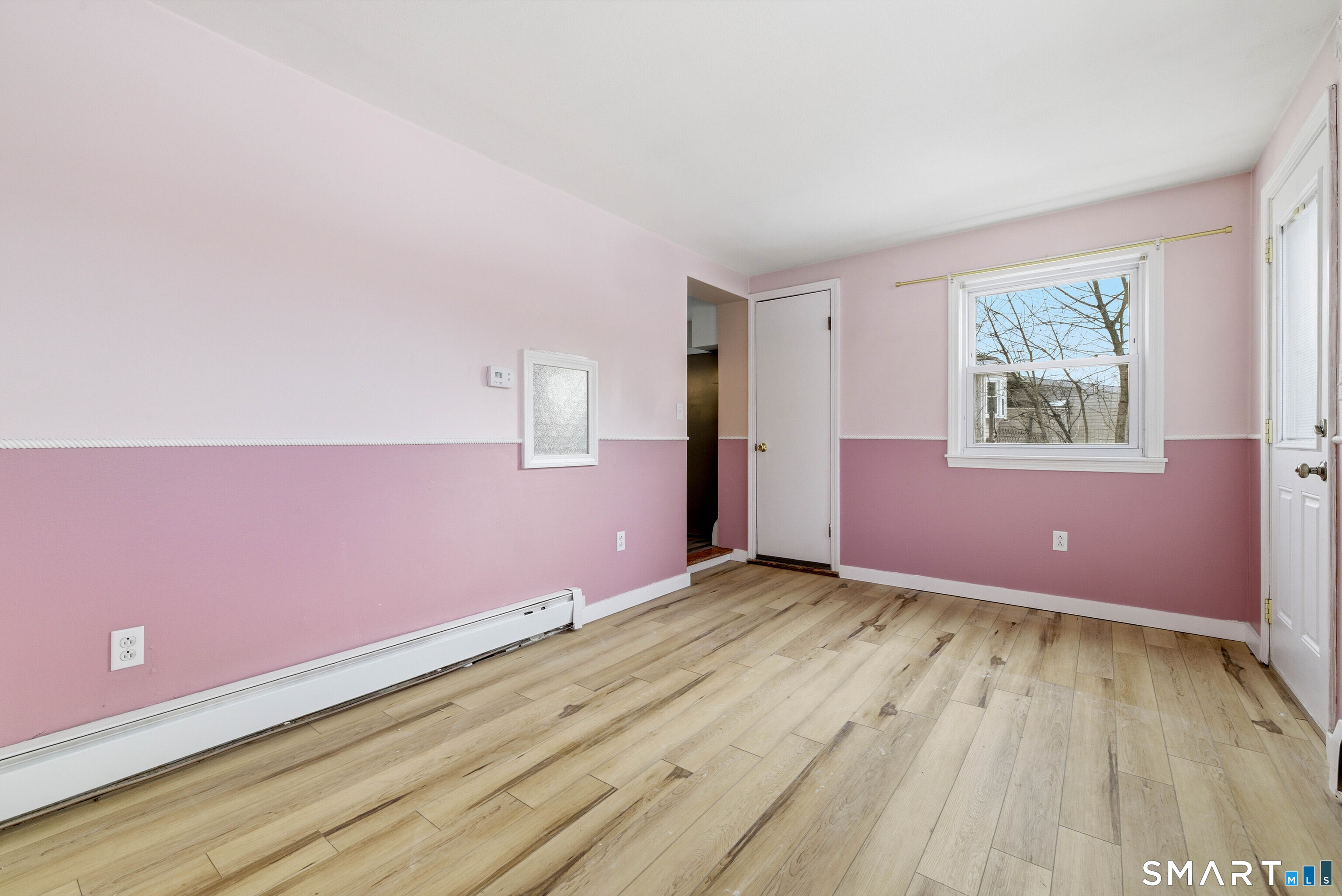 57 Hellstrom Road East Haven, CT 06512 - Photo 23 of 36 an empty room with wooden floor and windows