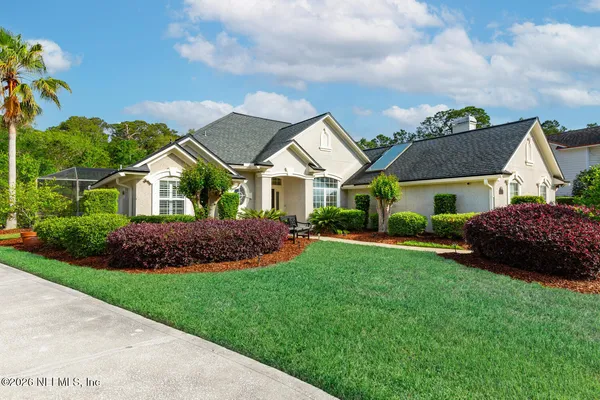 a front view of a house with a garden