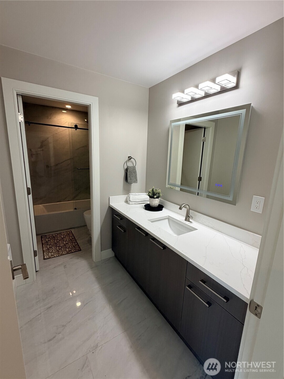 4305 Northeast 26th Court Renton, WA 98059 - Photo 40 of 40 a bathroom with a double vanity sink a mirror and a shower