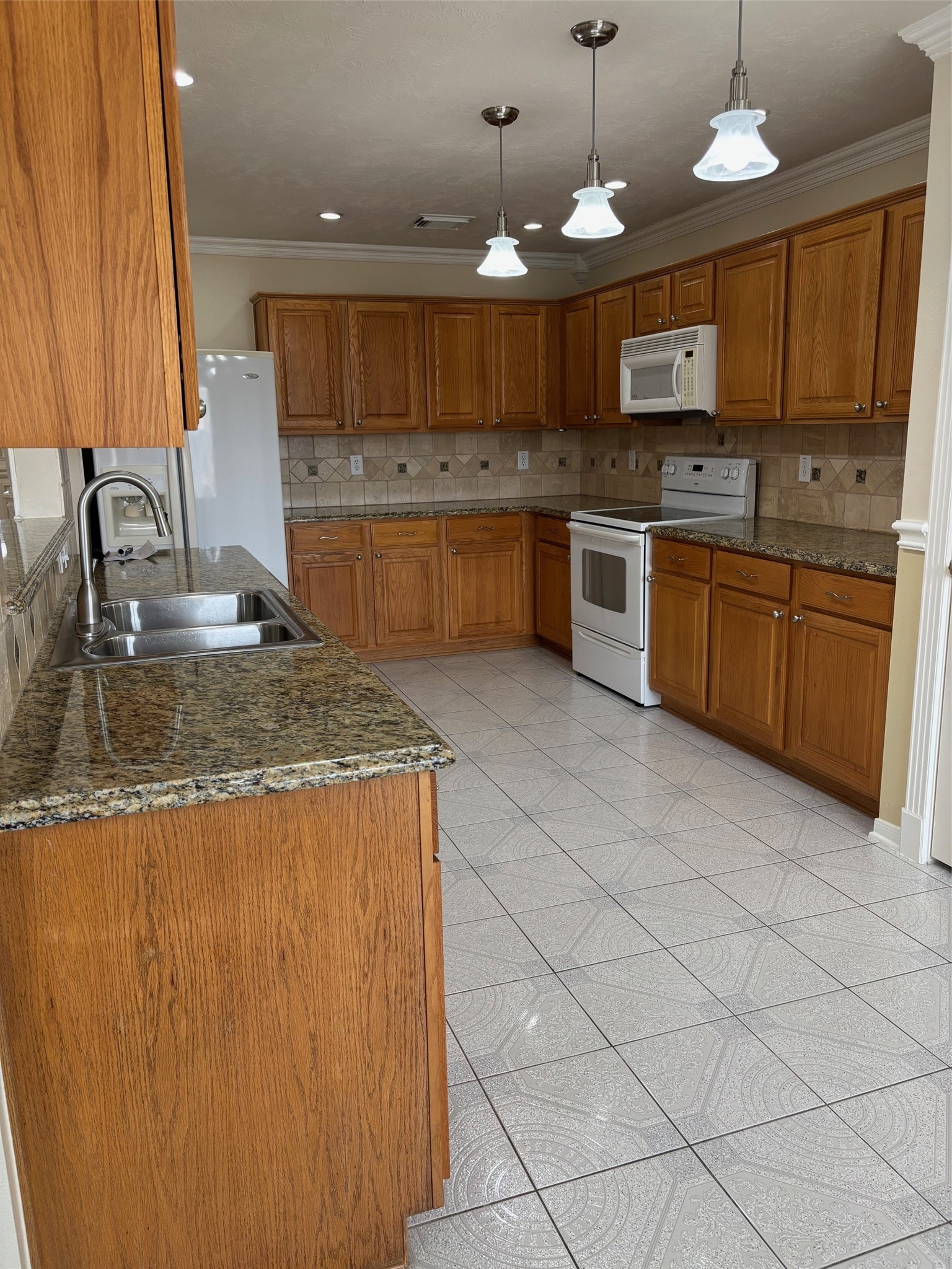 903 Christopher Baytown, TX 77521 - Photo 9 of 22 a kitchen with stainless steel appliances granite countertop a sink counter space cabinets and a stove