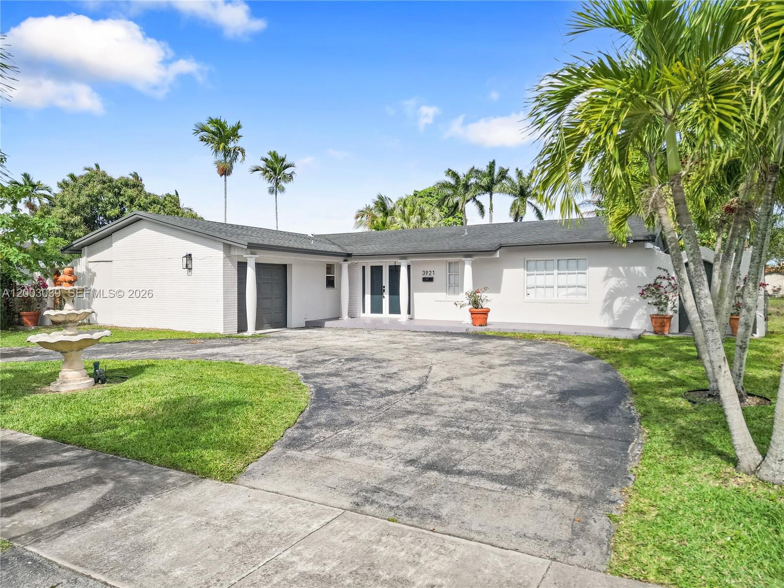 3921 Southwest 124th Court Miami, FL 33175 - Photo 1 of 22 a front view of a house with a garden and a tree